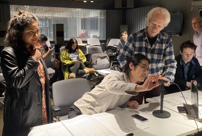 Group of students and a professor working in the screen scoring studio
