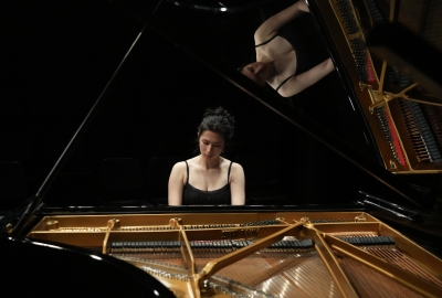 Honors student performing on grand piano