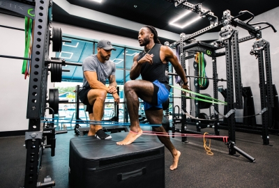 Sharif Tabbah working with a physical therapy patient in a gym