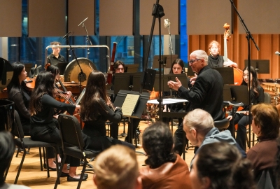 Conductor Jonathan Haas leading orchestra