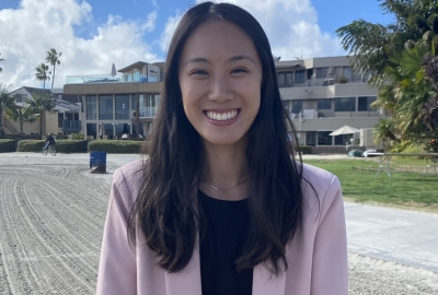 woman on front of a house smiling 