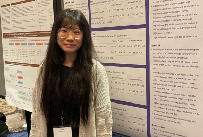 woman on front of poster wearing glasses