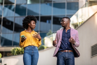 Photo of Black man and woman talking outside