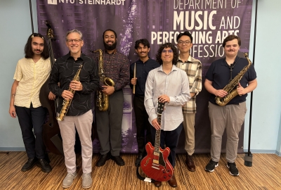 Group of jazz students in front of step and repeat banner