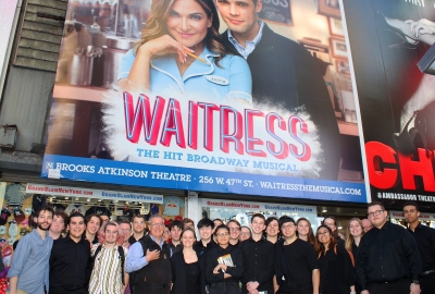 Large group of students in front on Waitress sign