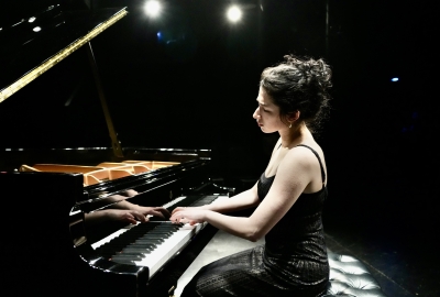 Piano student CiCi Fader playing a grand piano