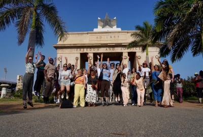 People jump in front of a monument