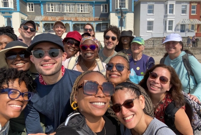 A group of smiling teachers poses for a photo in Weymouth, UK