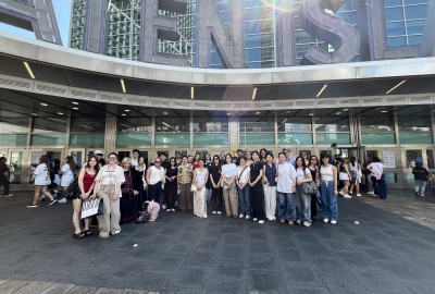 A group of students gather in front of the Staten Island Ferry Terminal.