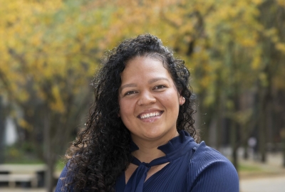 Professional Headshot of Sara-Lee, smiling with arms crossed comfortably in front