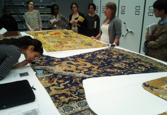 students examining fabric