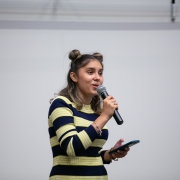 A photo of Katlyn Martins holding a microphone