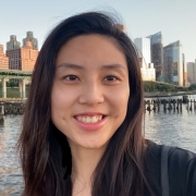 Leilei Xu in front of water and tall buildings