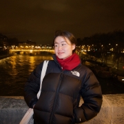 Melanie Cheung on a bridge over the Seine River in Paris