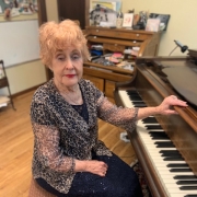 Charlotte Larue Grantier sits at a piano