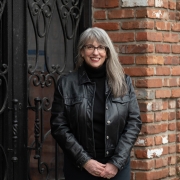 Headshot of Abby standing in all black clothes