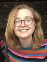 Picture of a blonde woman in glasses smiling.
