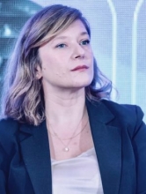 Photo of Odeta Barbullushi wearing a navy blue blazer