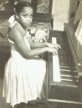 Eight-year-old Tania León practicing the piano at her home in La Habana, Cuba. 
