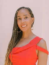 Educator, Heather Clarke smiles in a photo against a light colored background.
