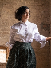 Portrait with brick background and openings in the wall that let the light in