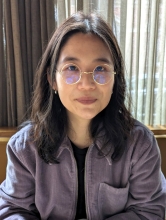 Sejin sitting with a purple jacket.