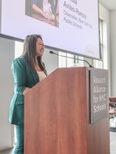 Melissa Aviles-Ramos stands at a podium