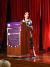 Daisy Fancourt speaks from a podium