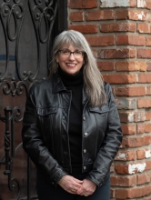 Headshot of Abby standing in all black clothes