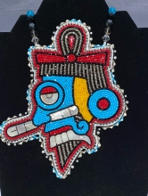A beaded Tlaloc beaded in Charlotte tricut beads with hand-cut mother-of-pearl, made by Itzhecatl De La Cruz