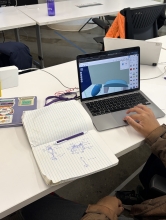 A student works on a 3D model on their computer