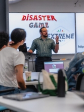 Maurice Boothe Jr. stands at the front of the class teaching.