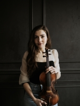 Alexa holds a violin