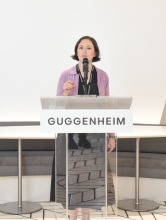 Isabella Caporuscio speaks into a microphone