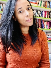 Dr. Honey Crawford sits in front of a bookshelf 