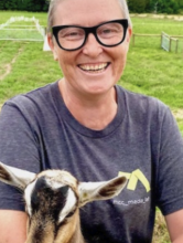 Prof. Jamie Skye Bianco with a baby goat