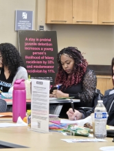 A workshop attendee takes notes 