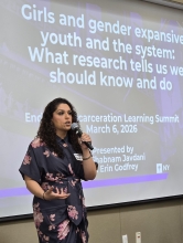 Dr. Shabnam Javdani stands in front of Powerpoint presentation as she facilitates a workshop in March 2026. 