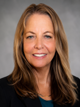 female professor smiling into camera