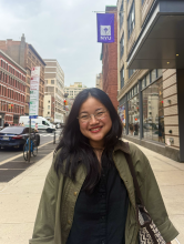 Photo of Josephine in NYC with NYU purple flag in the background