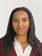 Headshot of Selam Feleke, wearing red and white 