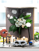A diorama featuring plants and wires