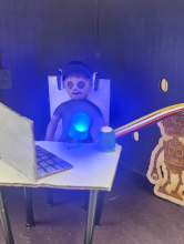 a diorama with a figurine using a computer