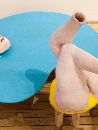 Sculpture of figure in blue form. 