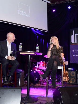 Larry Miller and guest Natalia Nastaskin sit together on stage at an NYU Steinhardt Music Business event