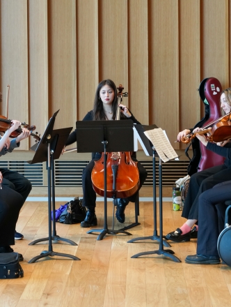 NYU String ensemble playing in the Paulson Center
