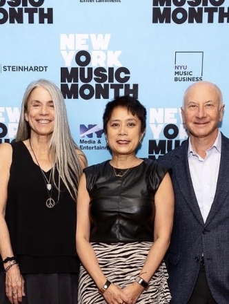 NYU faculty in front of NY music month step and repeat