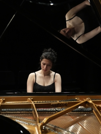 Honors student performing on grand piano