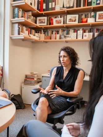 Professor Dana Burde engaging in conversation with students