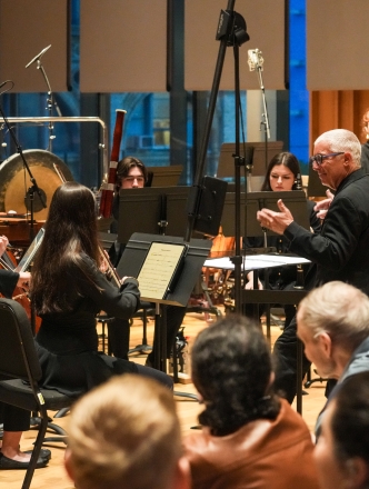 Conductor Jonathan Haas leading orchestra
